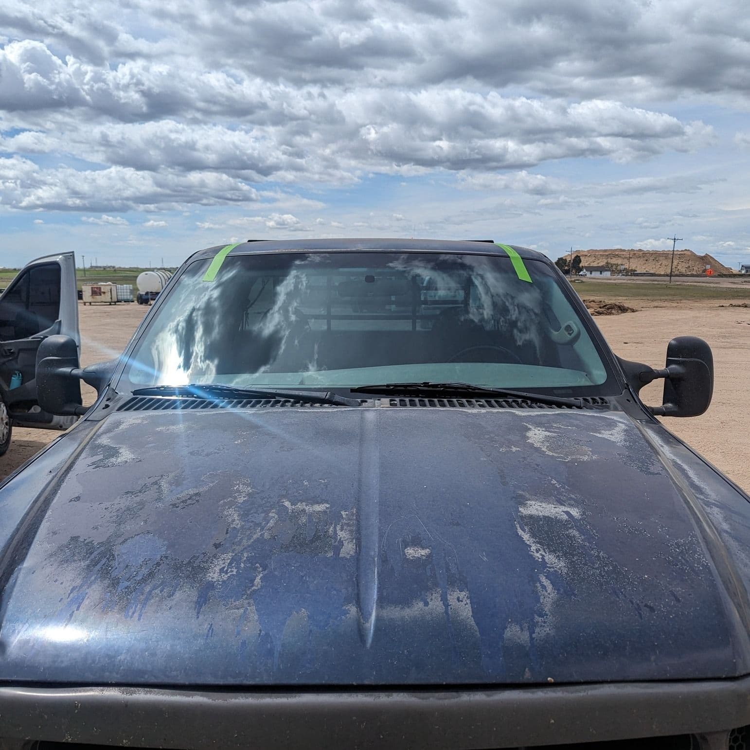 Work truck windshield replaced on site at a job yard