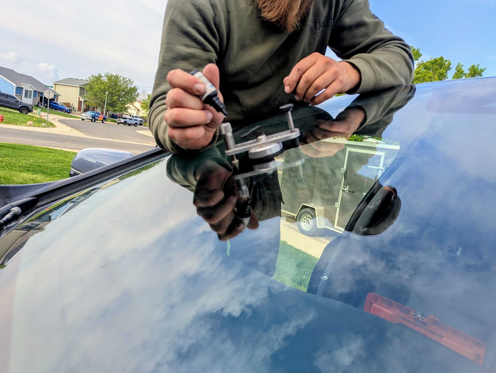 Patriot technician applying resin during a windshield chip repair